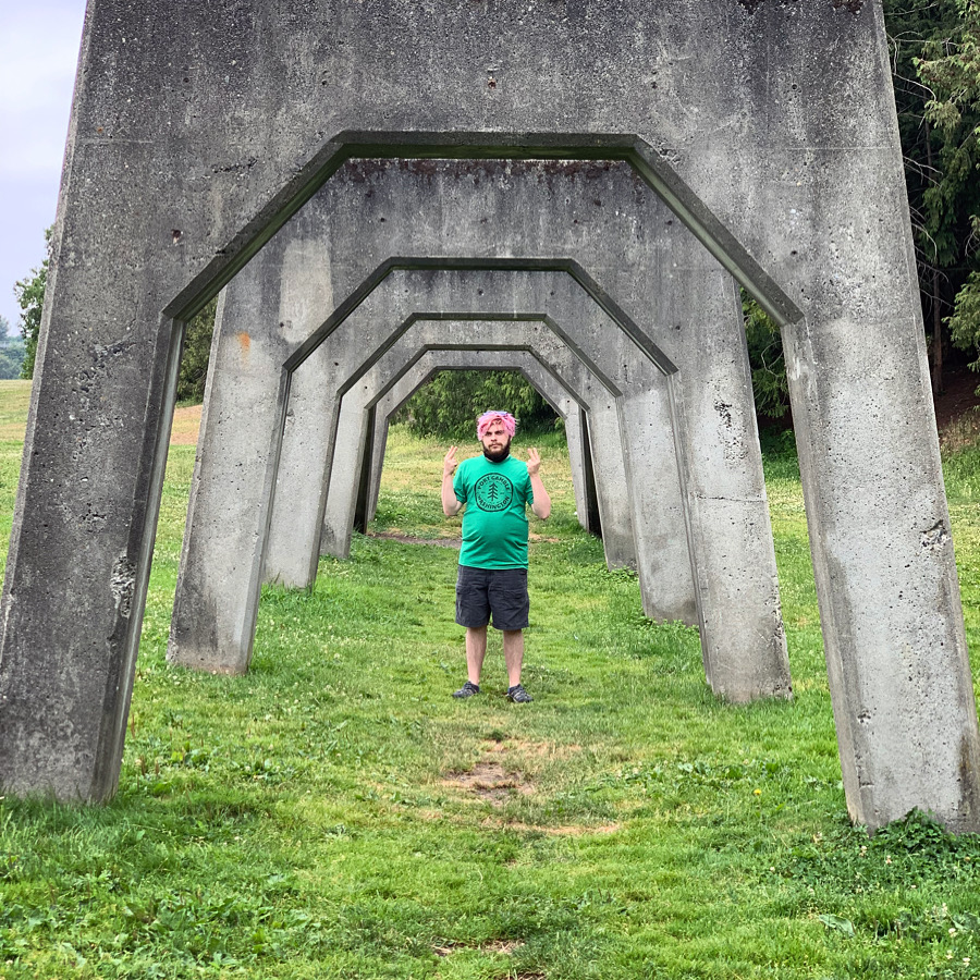 My son standing under concrete arches on Gas Works island
