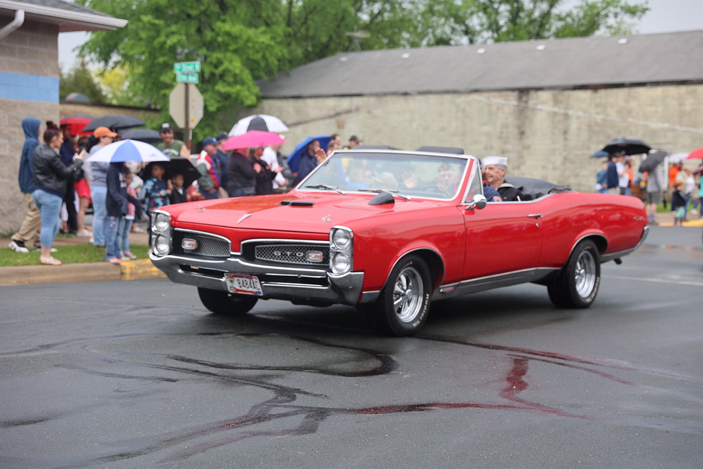 A vintage red convertible in the Memorial Day Parade