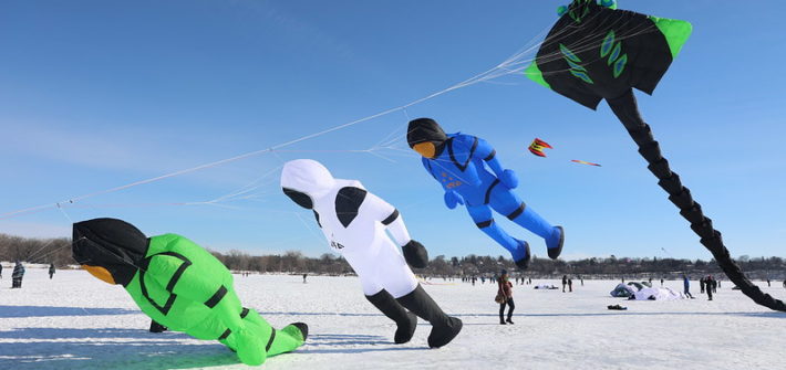 Three giant deep sea diver kites trailed by a giant manta ray kite