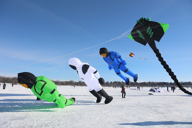 Three giant deep sea diver kites trailed by a giant manta ray kite