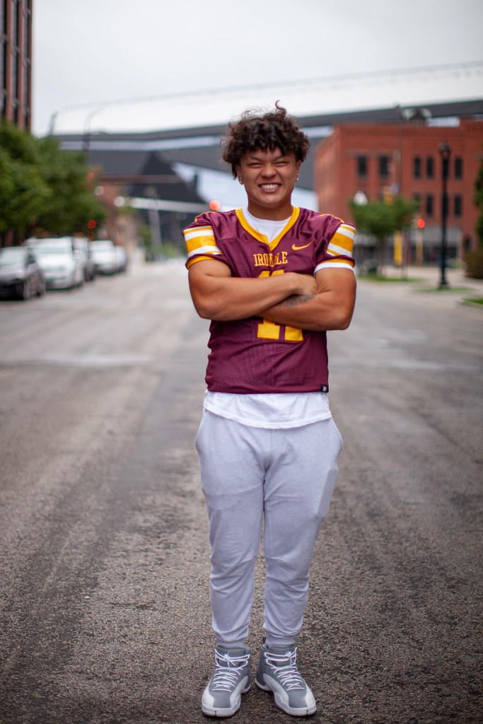 A young man in a football uniform making a fierce face