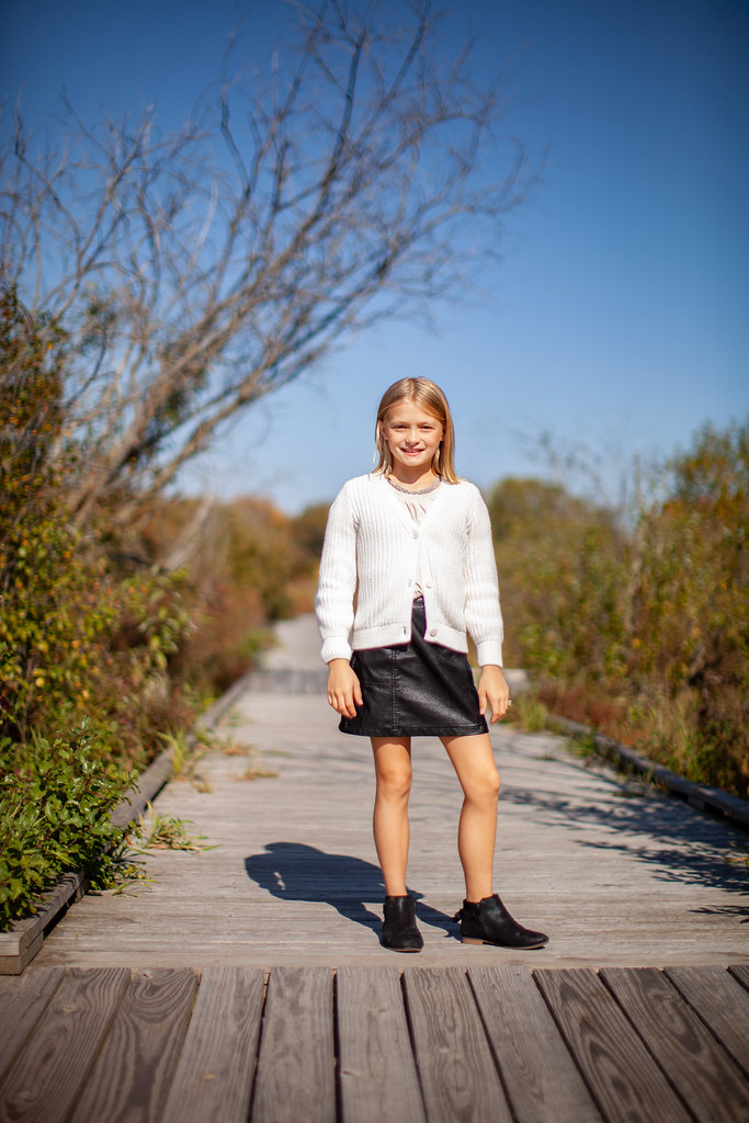 The middle grandchild, a girl, posing outdoors in park